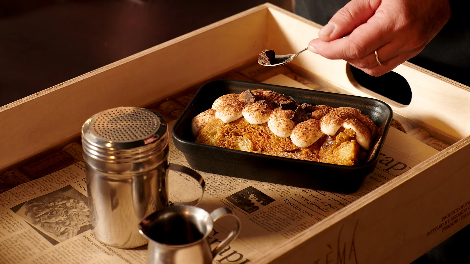 Italian-style dessert topped with cream and cocoa, served on a sharing tray at PACINI.